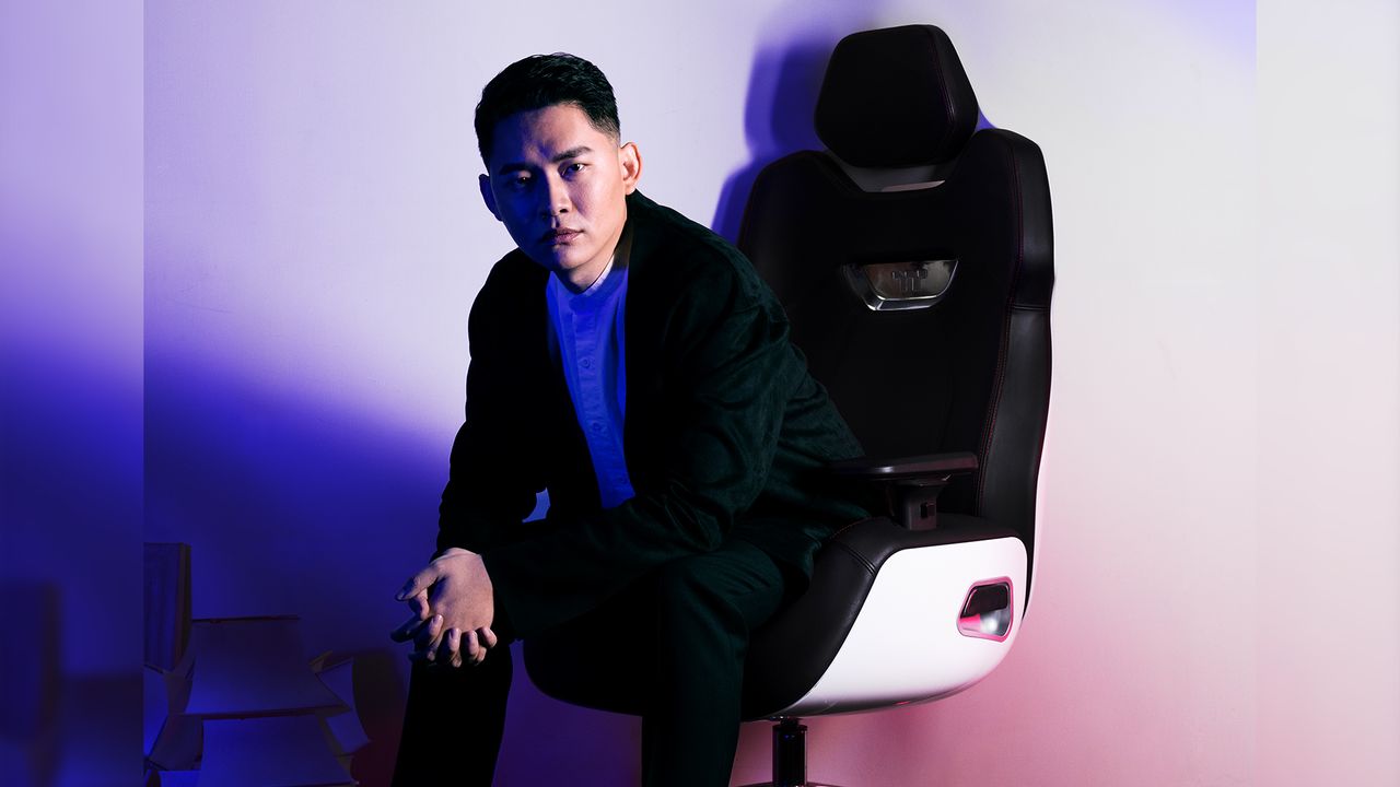 A man looking very serious sitting in a scifi chair.