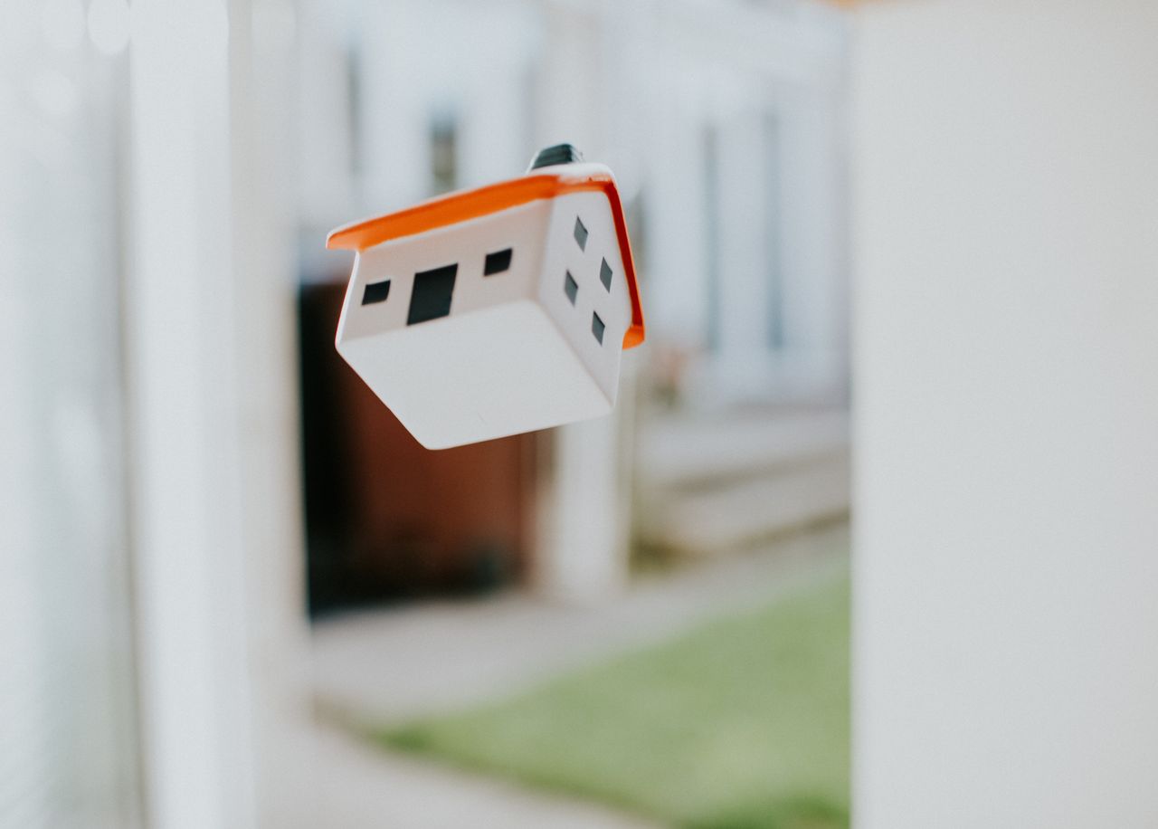 a house figurine falling