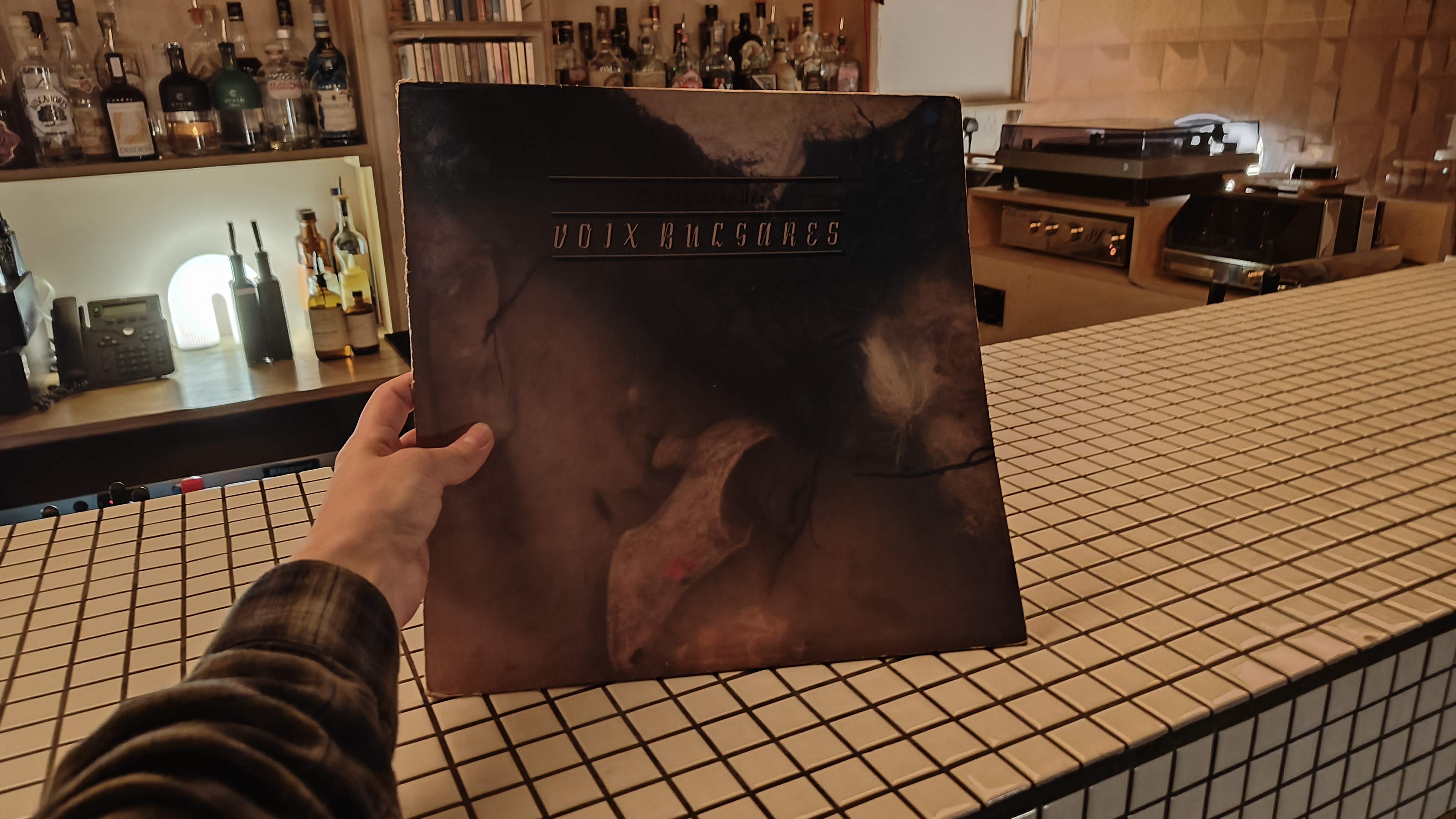 The vinyl album of Voix Bulgares on a white checkered bar table.