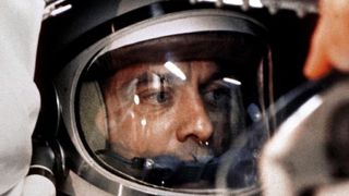 a person's face can be seen through the glass dome of a spacesuit helmt