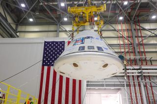 The Starliner crew module is hoisted in Boeing's Commercial Crew and Cargo Processing Facility on Jan. 19, 2023 before being mated to a new service module for NASA's Boeing Crew Flight Test.