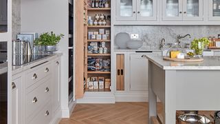 Pale grey kitchen with tall pantry storage unit to show how to organize a small kitchen with larder unit