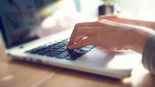 Woman typing on a laptop