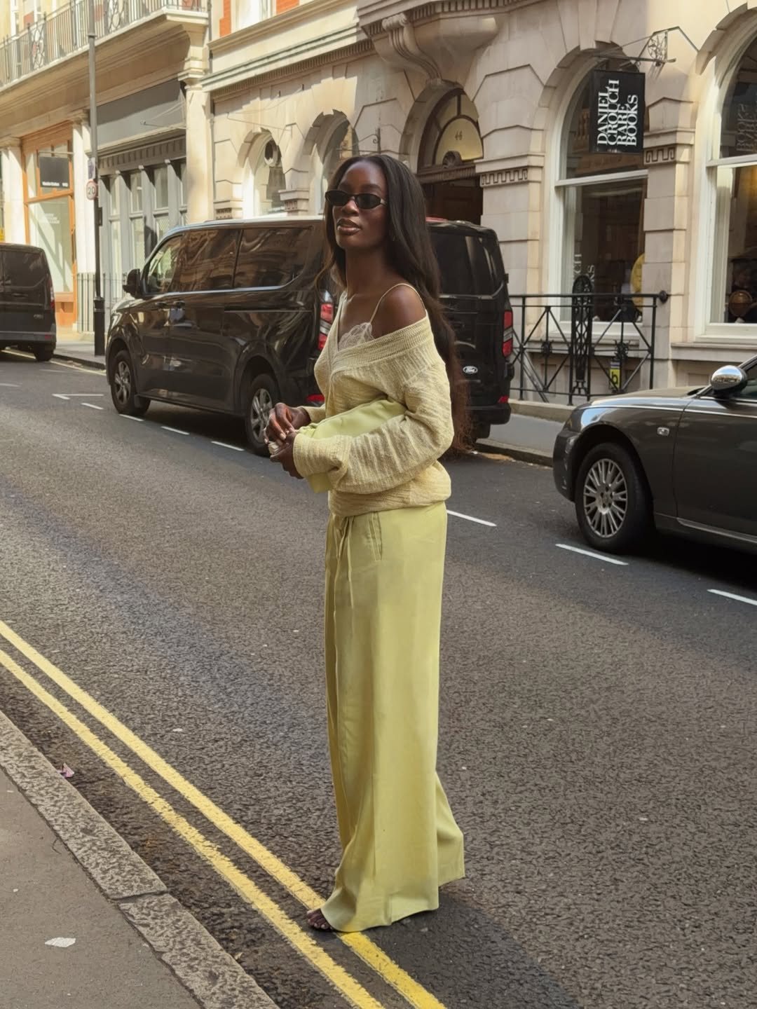 Liv in a lace bralette and yellow jumper