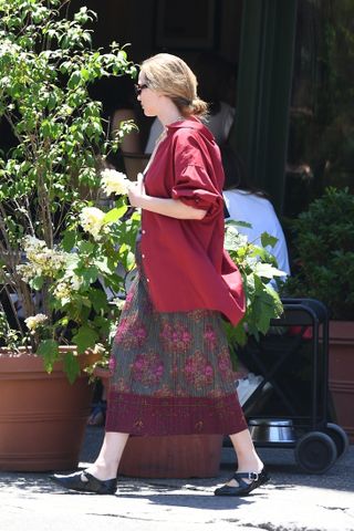Jennifer lawrence wearing the mary janes trend with a crimson button down and floral skirt in manhattan