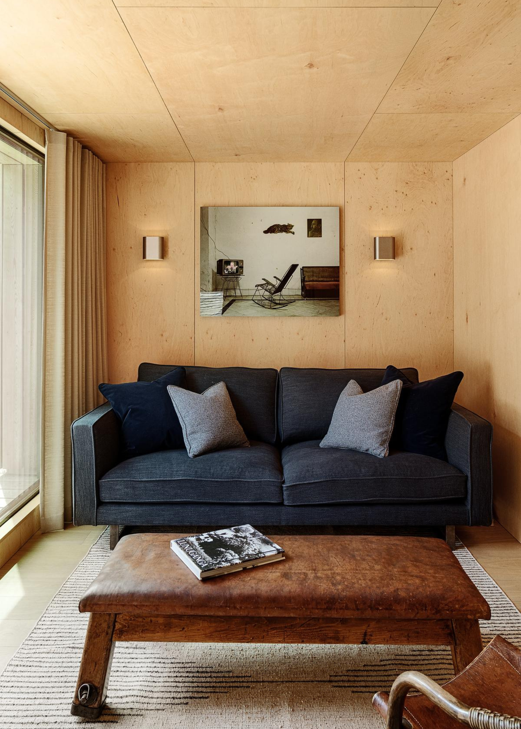 wooden room with a sofa and leather coffee table