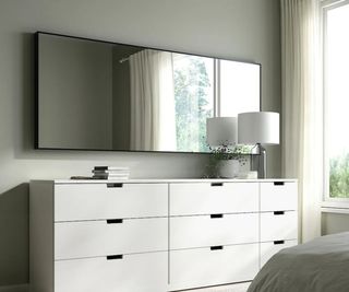 An IKEA Hovet mirror above drawers in a modern bedroom