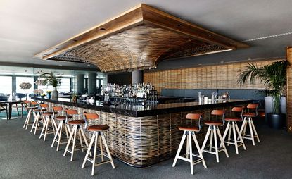 Bar area with orange stools & wicker lining