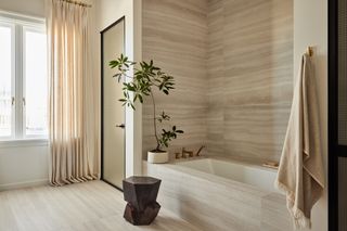 A bathroom with floor-length curtains