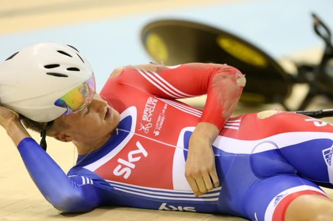 Britain's Sam Harrison checks his wounds after crashing in qualification for the team pursuit