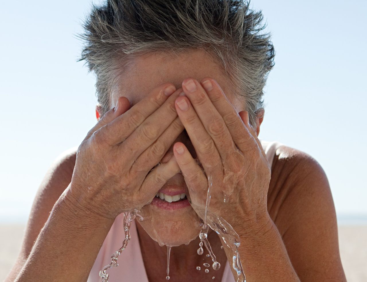 Woman washing her face