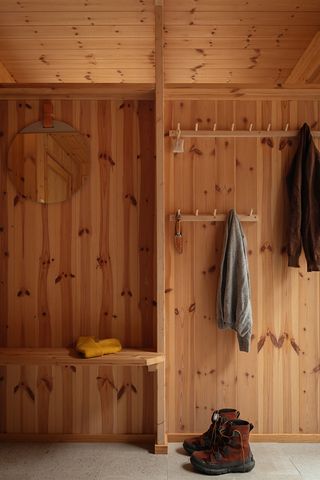 detail of timber interiors at hat house, with hooks for coats