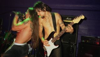 Anthony Kiedis (left) and Dave Navarro of the Red Hot Chili Peppers perform onstage at the Subterania Club in London on September 27, 1995