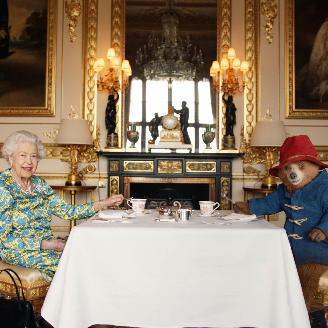 Queen Elizabeth sitting at a table with Paddington Bear