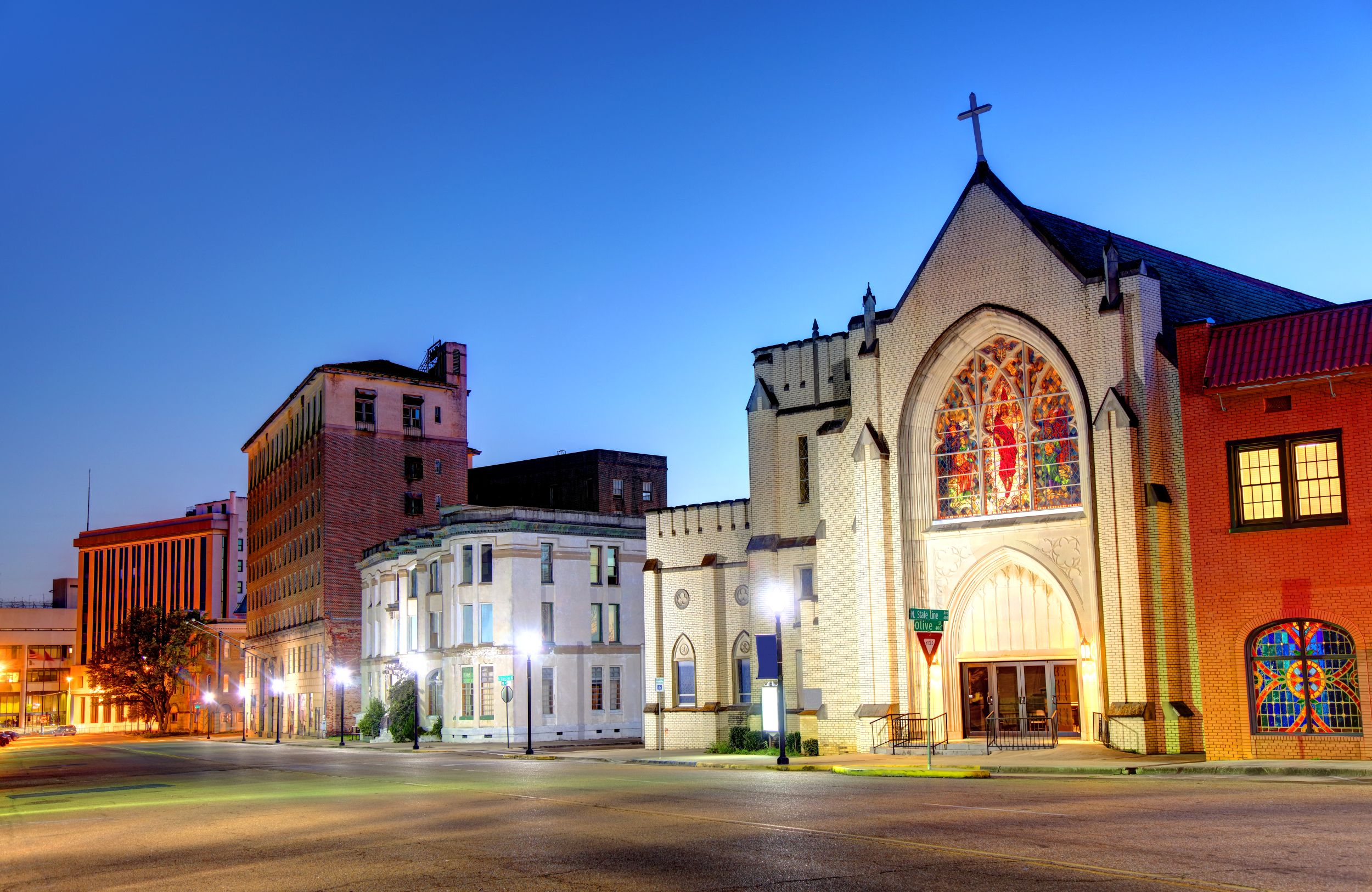 A church in the city of Texarkana with buildings along the high street at sunset