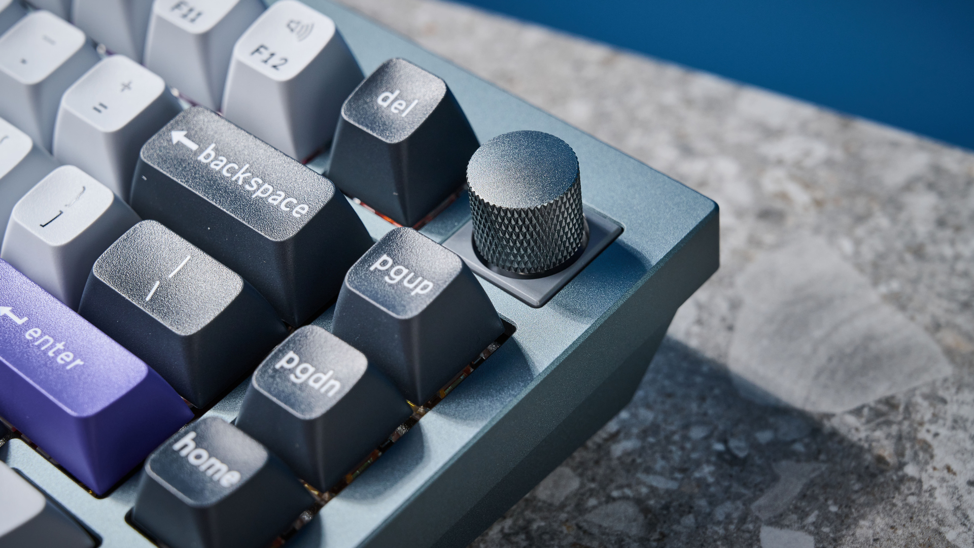 A photo of the Keychron Q1 Pro in gray aluminum with white, black and purple keycaps.