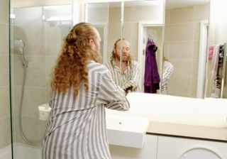 bathroom with huge cabinet filled with Ore's grooming products