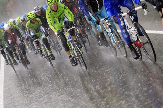 The Giro peloton amidst heavy rain during stage 12