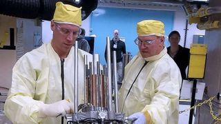 Image of technicians with components for the Kilopower reactor