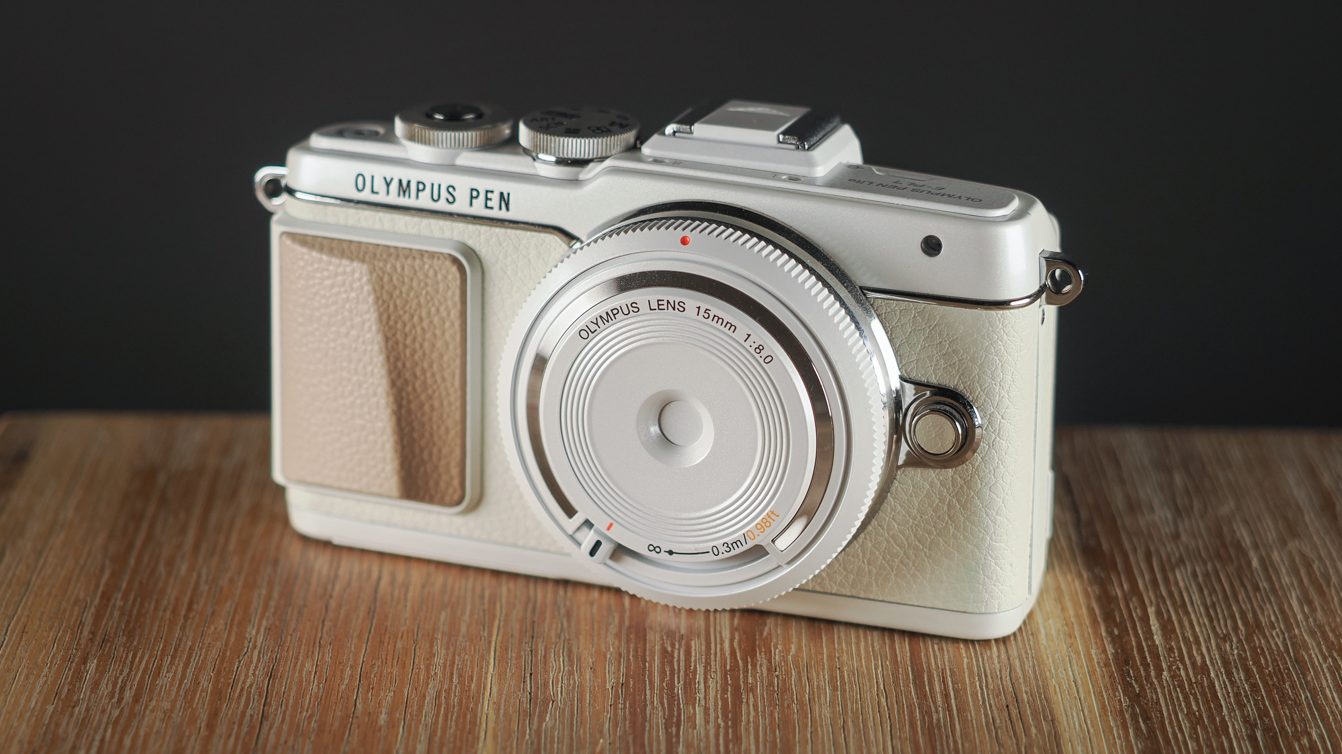 Olympus PEN E-PL7 on a wooden surface