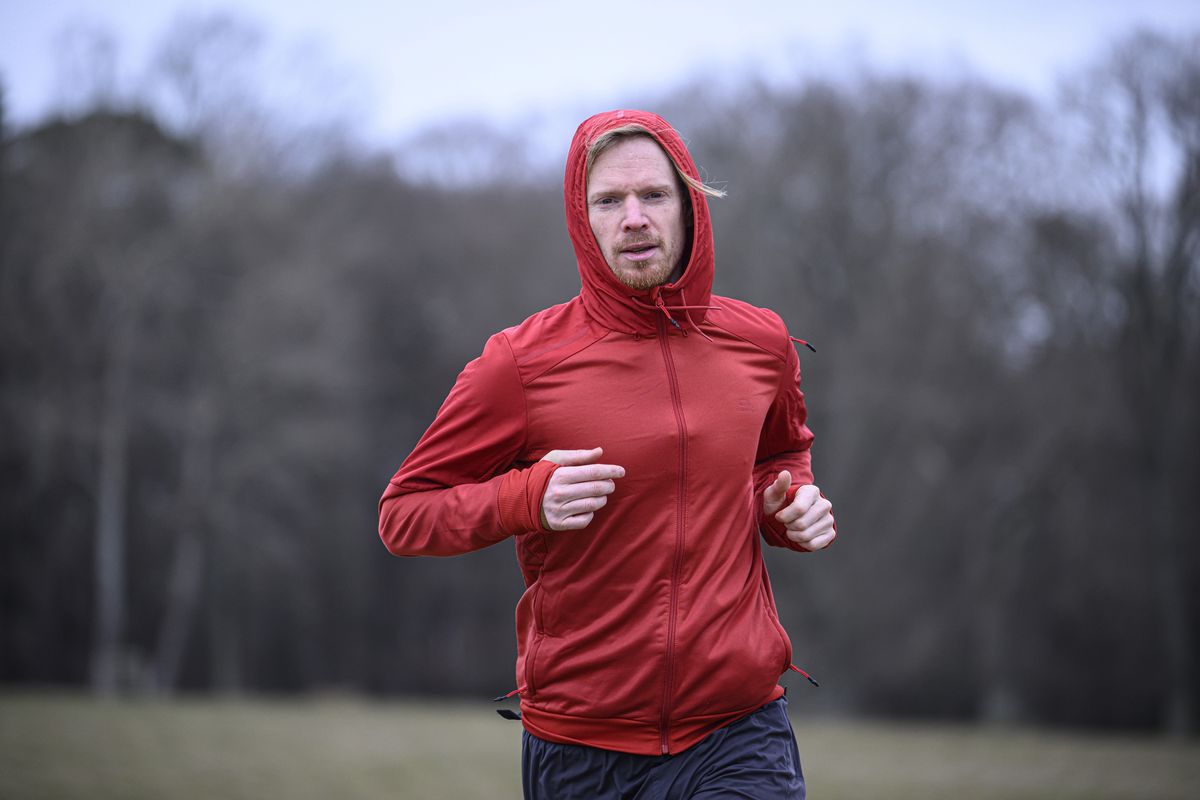A man in a red jacket running