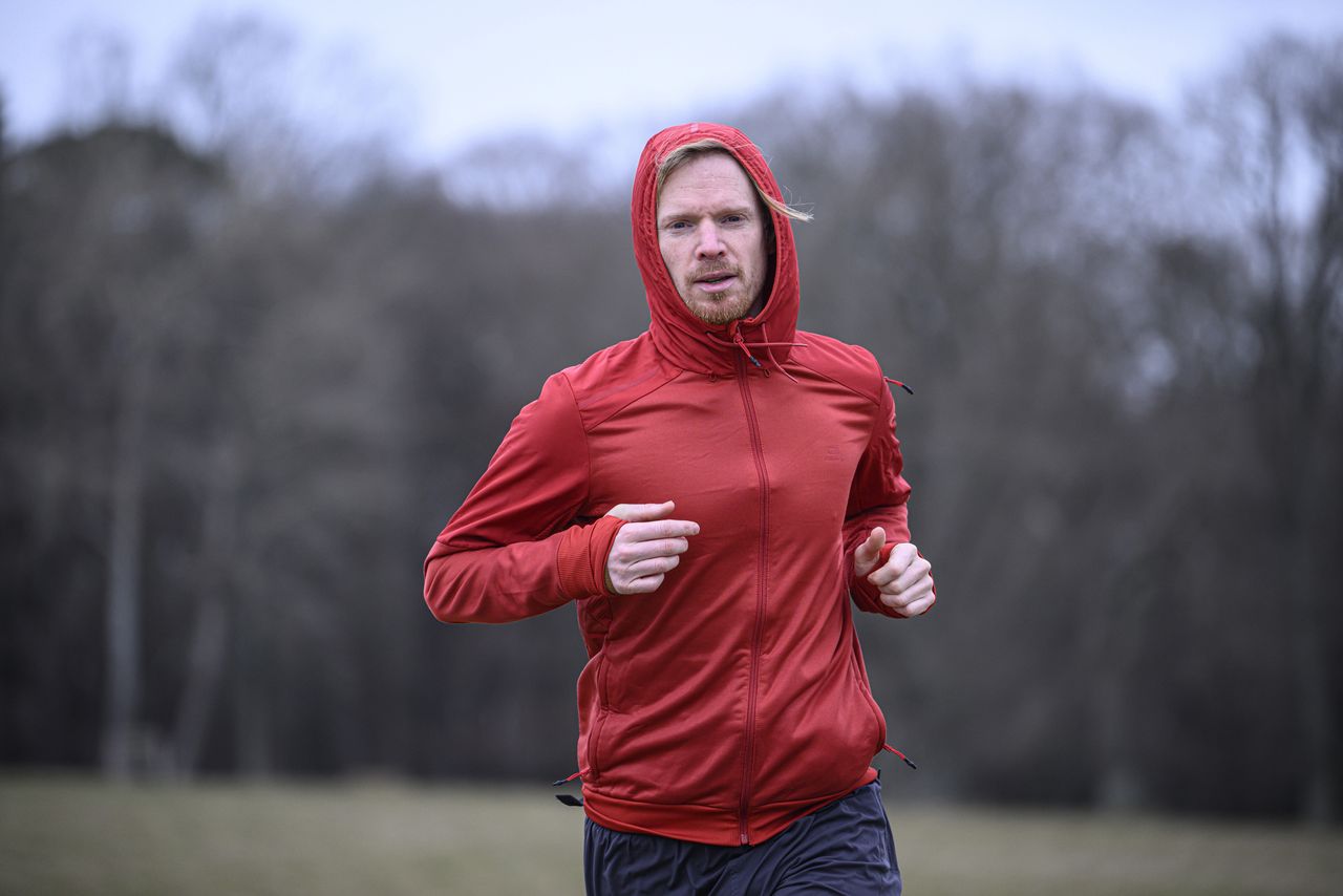 A man in a red jacket running