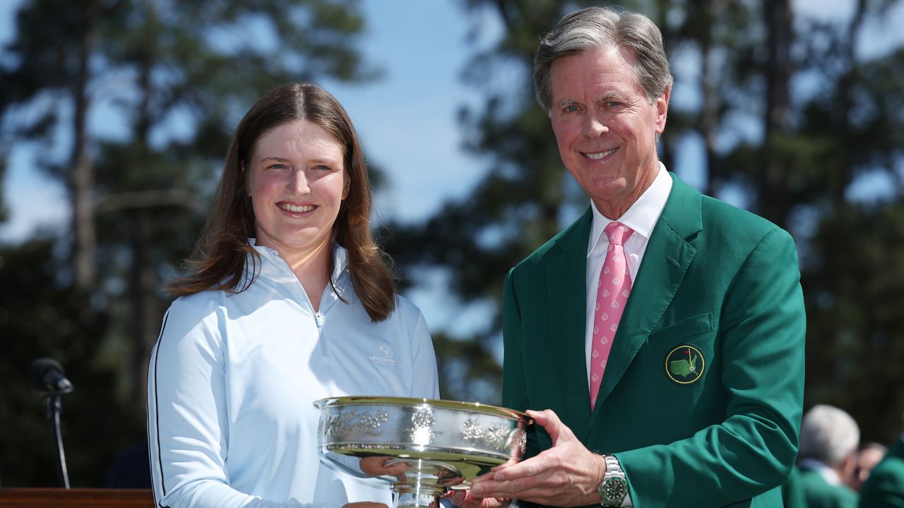 Fred Ridley hands Lottie Woad the Augusta National Women&#039;s Amateur trophy