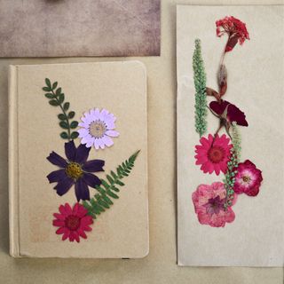 Beautiful dried flowers and notebook on vintage background