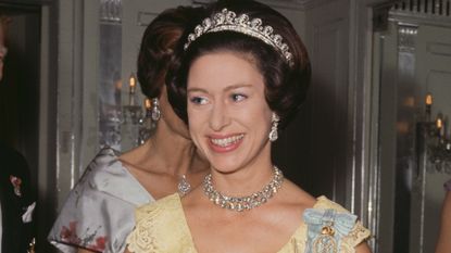 Princess Margaret (1930 - 2002) wearing a yellow evening dress, circa 1970. 