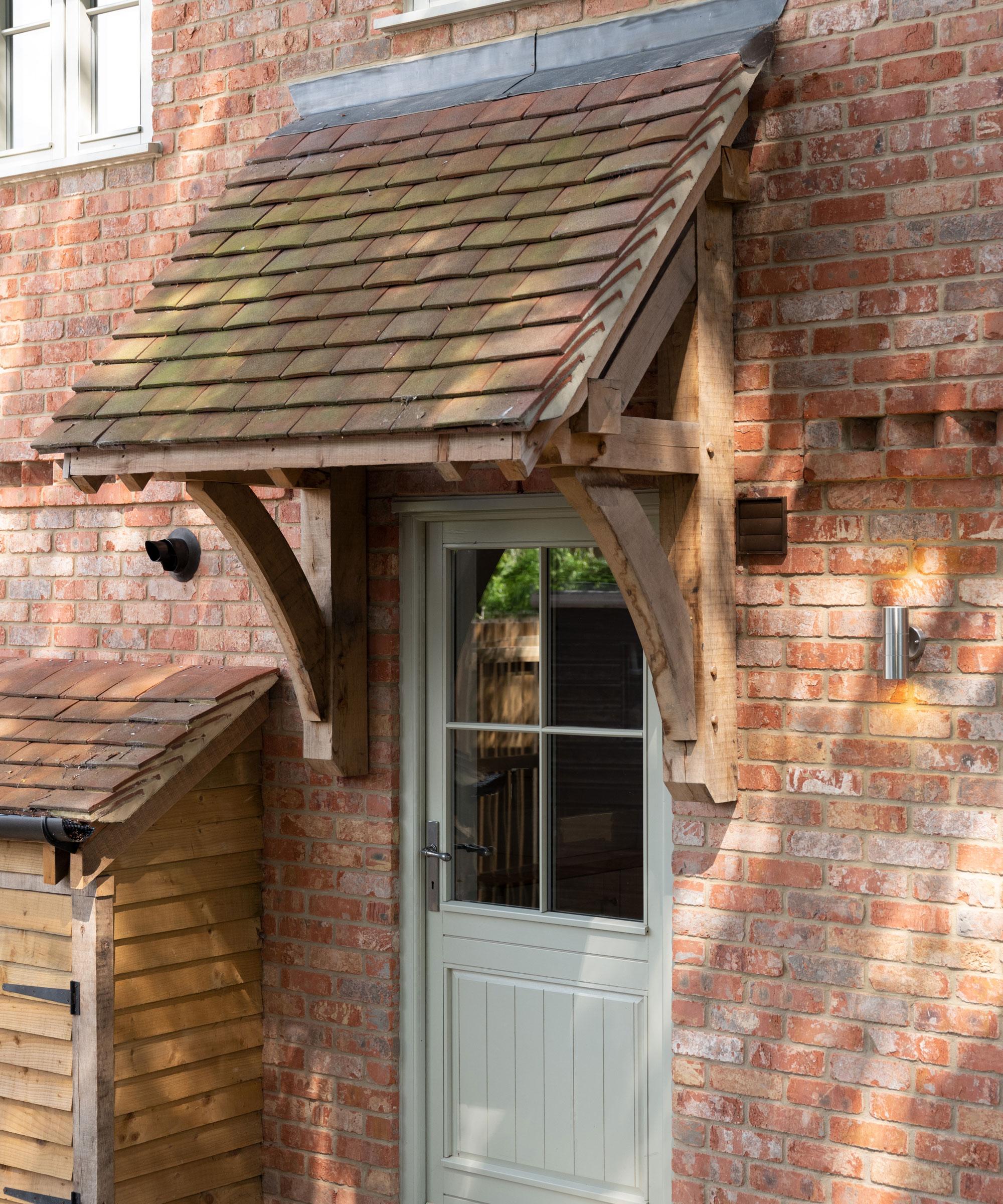 oak frame canopy over part glazed wooden front door