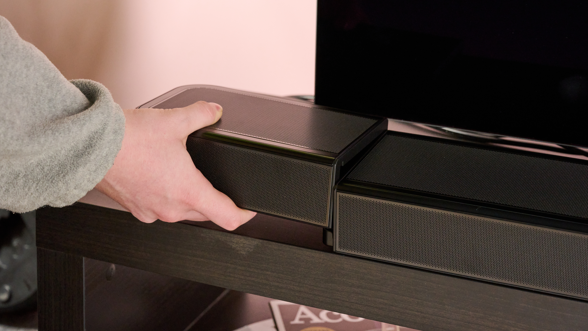 Man attaching surround speaker to JBL Bar 1300MK2