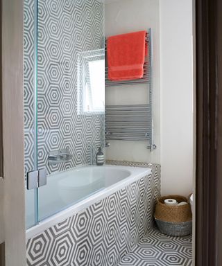 bathroom with textured tiles and bathtub