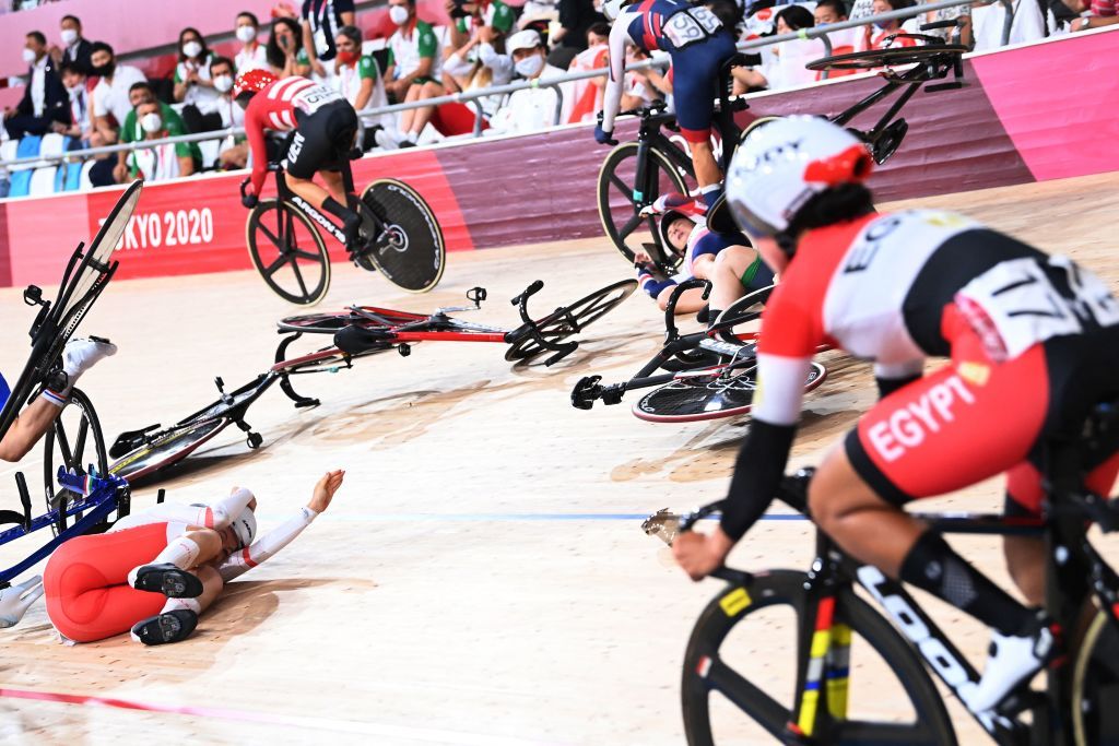 Polands Daria Pikulik L and Britains Laura Kenny R crash while competing in the womens track cycling omnium scratch race during the Tokyo 2020 Olympic Games at Izu Velodrome in Izu Japan on August 8 2021 Photo by Peter PARKS AFP Photo by PETER PARKSAFP via Getty Images