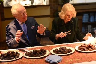 King Charles III and Queen Camilla meet British Muslim women at a female led restaurant and help pack donation boxes ahead of Ramadan, at Darjeeling Express, Kingly Court, Carnaby Street on February 26, 2025 in London, England