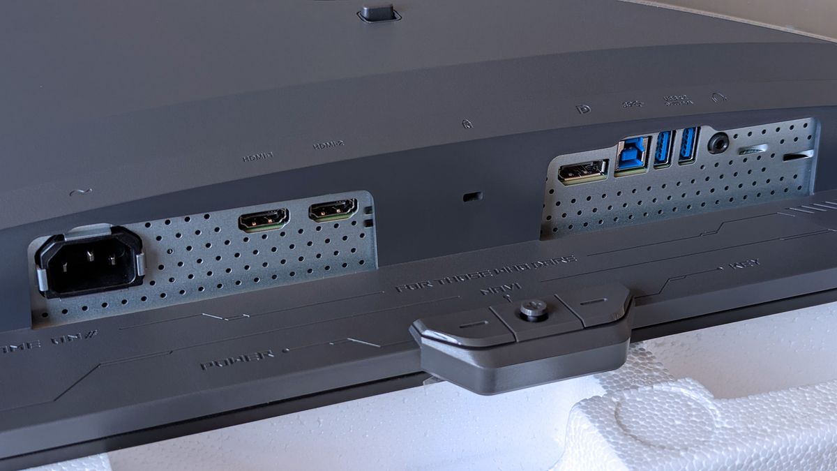 Close-up of the ASUS ROG Strix OLED monitor&rsquo;s I/O panel featuring power, HDMI, DisplayPort, USB upstream/downstream, and headphone jack.