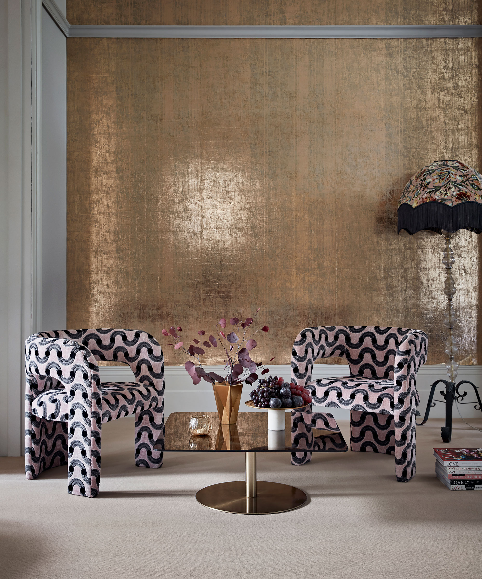 1980s-inspired living room with gold wallpaper and cream carpet and statement furniture