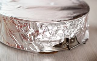 A baking pan covered in foil ready to be steamed