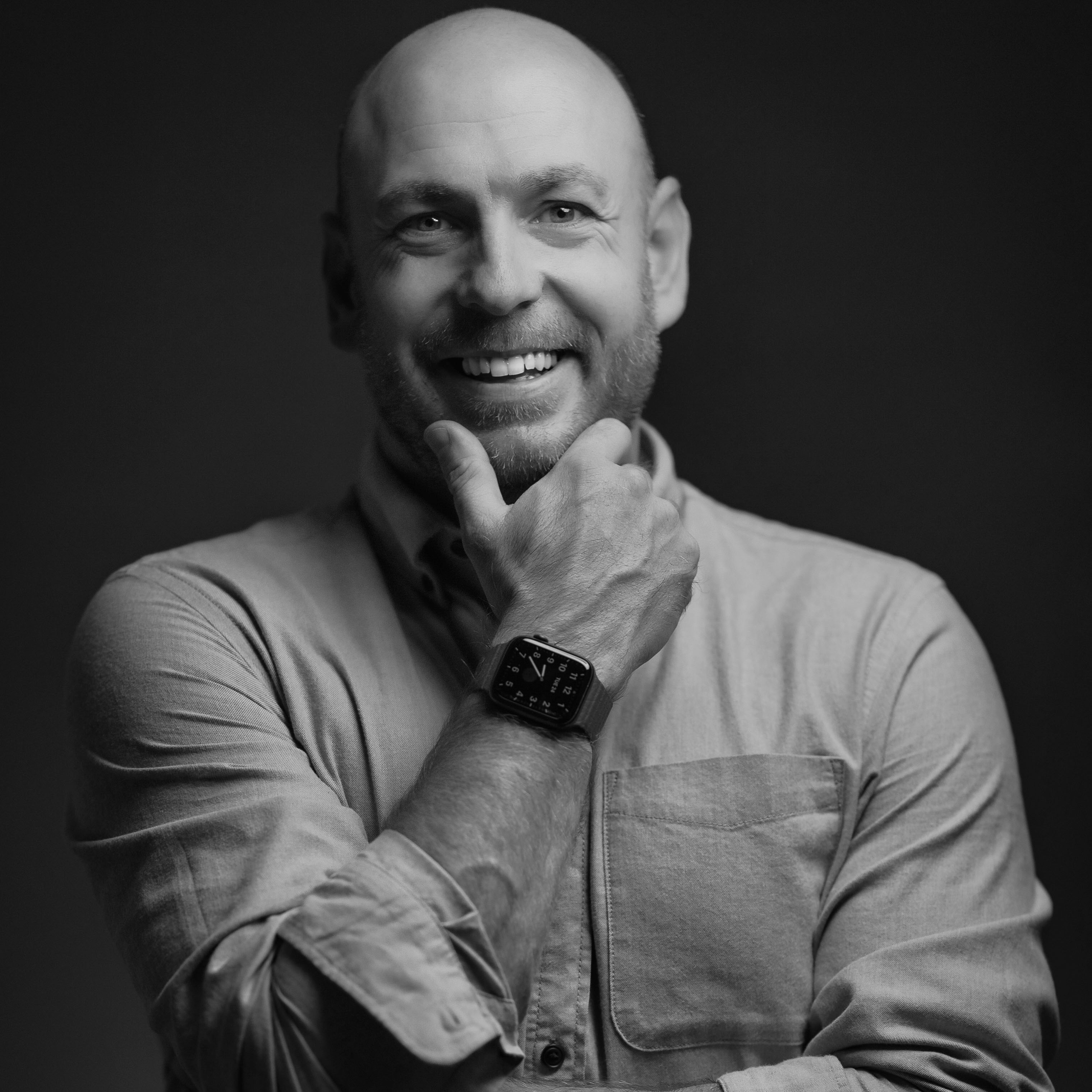 A monochrome headshot of photographer Vince Preston, smiling