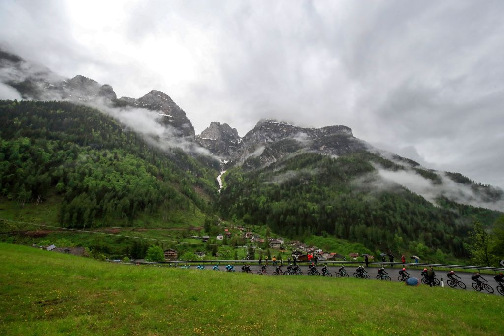 TOPSHOT The pack rides through the mountains during the 16th stage of the Giro dItalia 2021 cycling race 212km between Sacile and Cortina dAmpezzo on May 24 2021 Photo by Luca Bettini AFP Photo by LUCA BETTINIAFP via Getty Images