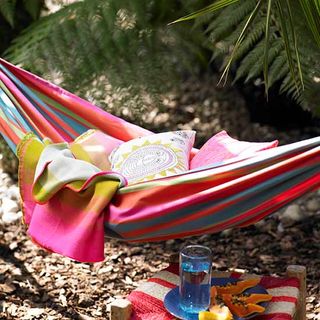 colourful hammock with cushions and glass
