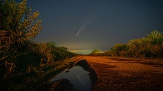 Comet C/2024 G3 (Atlas) reflects on a puddle on a dirt road near Firmat, Argentina, as it continues its journey through the cosmos.