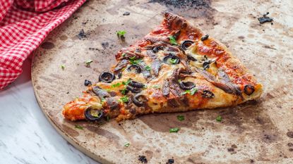 slice of pizza on a pizza stone