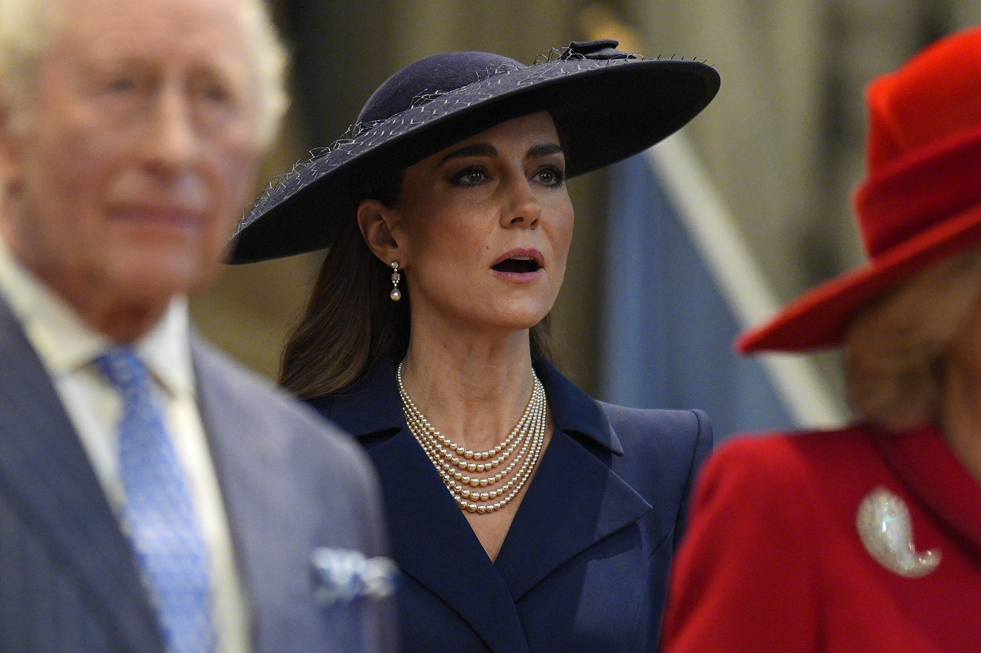 Princess Kate wearing a blue hat and singing