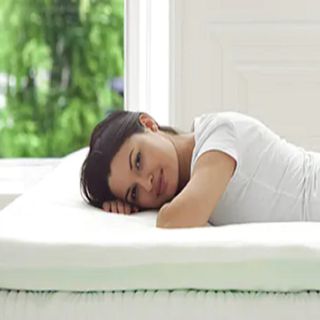 A person lying on a memory foam mattress