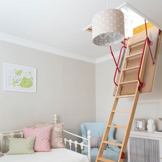 Kids bedroom with wooden stepladder coming down from loft hatch