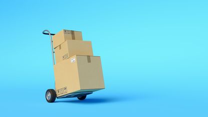 hand truck with moving boxes on it for moving to low-tax states
