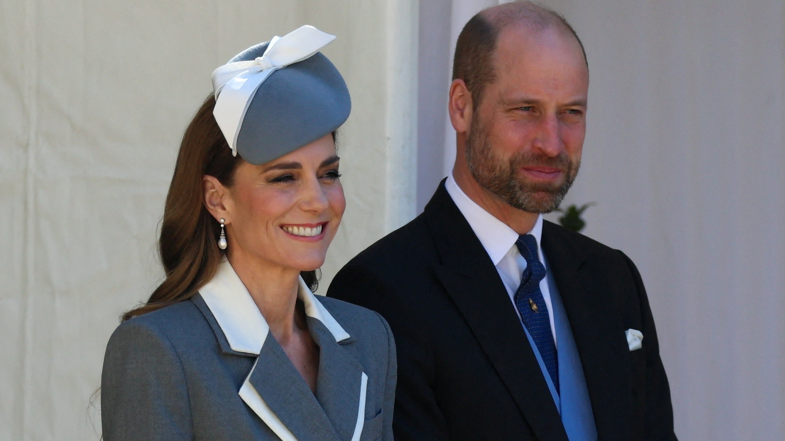 Catherine, Princess of Wales and Prince William, Prince of Wales react during a ceremonial welcome in the Quadrangle at Windsor Castle
