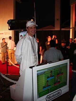 A Nintendo employee rides a Segway with a Wii and flat screen monitor attached to it.