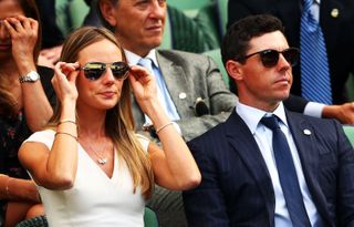 Rory McIlroy and Erica Stoll watch tennis at Wimbledon