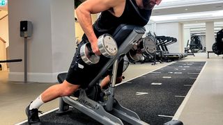Calum Sharma, personal trainer at the BodyLab, performs the second step of a chest-supported row